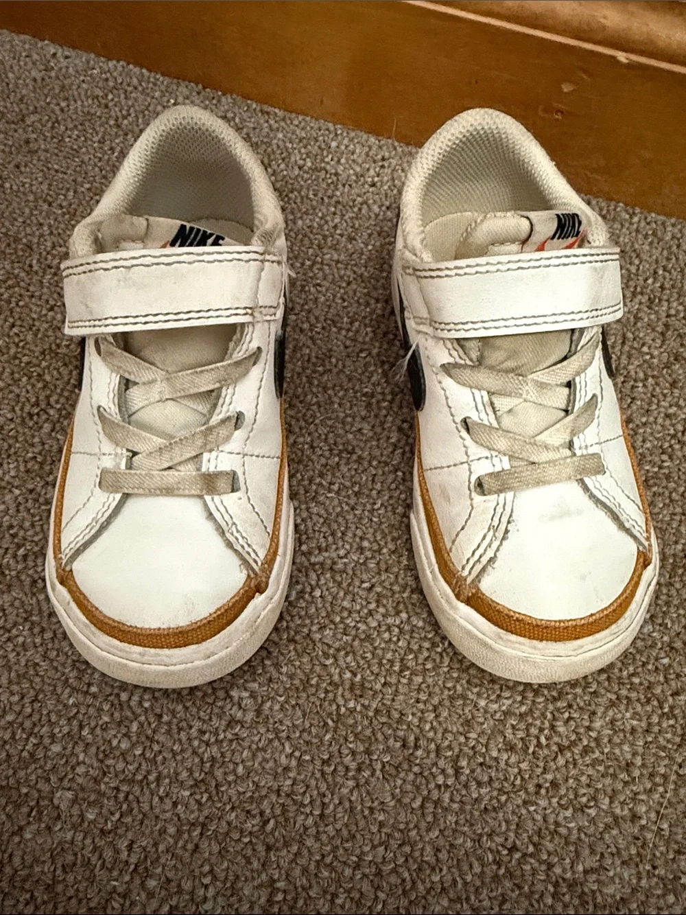 Nike Kids White Sneakers with Black Swoosh and Brown Trim